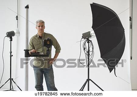 Stock Photography - Professional photographer in his studio. Fotosearch
