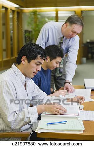 Stock Image - Professor giving instruction to college students. Fotosearch