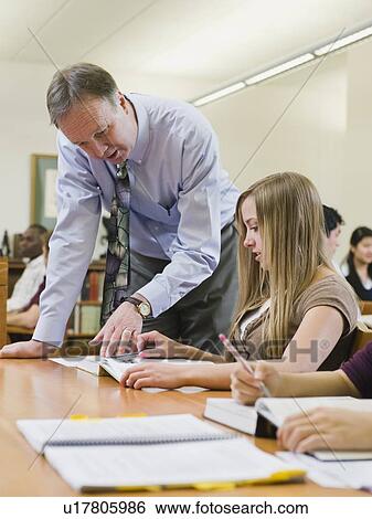 Professor giving instruction to college student View Large Photo Image Stock Photograph - Professor giving instruction to college student. Fotosearch