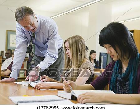 Professor giving instruction to college student View Large Photo Image Stock Photography - Professor giving instruction to college student. Fotosearch