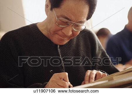 Senior student writing in notebook View Large Photo Image Stock Photograph - Senior student writing in notebook. Fotosearch