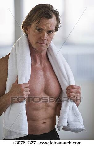 Shirtless man with a towel around his neck View Large Photo Image Stock Photo - Shirtless man with a towel around his neck. Fotosearch