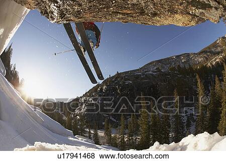 Stock Photo - Skier mid jump in Aspen Colorado. Fotosearch