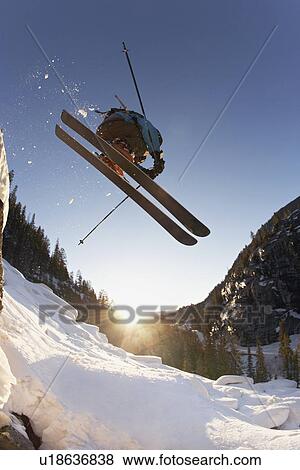 Stock Photo - Skier mid jump in Aspen Colorado. Fotosearch