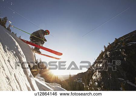 Stock Photograph - Skier mid jump in Aspen Colorado. Fotosearch