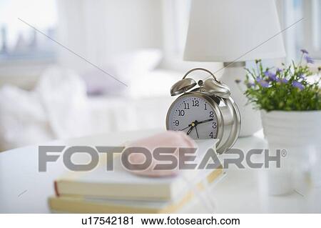 Sleep mask books and alarm clock on bedside table View Large Photo Image Stock Image - Sleep mask books and alarm clock on bedside table. Fotosearch