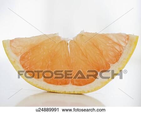 Stock Image - Slice of fresh grapefruit. Fotosearch