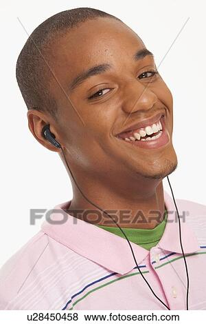 Smiling man wearing earphones View Large Photo Image Stock Photo - Smiling man wearing earphones. Fotosearch