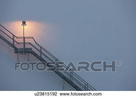 Stock Image - Stairs and light on an oil tank. Fotosearch