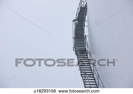Stock Photo - Stairs leading to oil tank. Fotosearch
