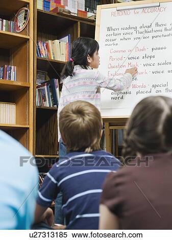 Stock Photography - Student giving presentation to fellow students. Fotosearch