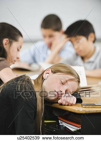 Stock Photo - Student sleeping at her desk. Fotosearch