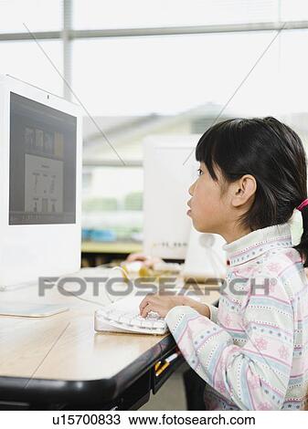Student working on computer in classroom View Large Photo Image Stock Image - Student working on computer in classroom. Fotosearch