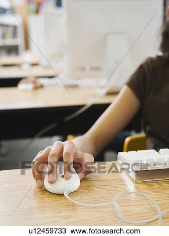 Stock Image - Students hand on computer mouse. Fotosearch