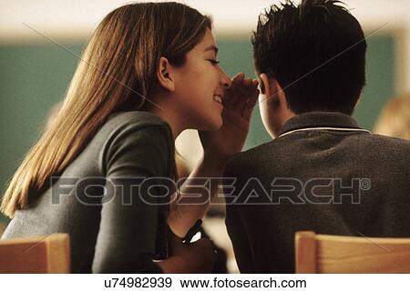 Stock Photo - Students whispering in class. Fotosearch