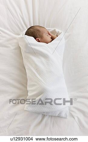 Picture - Swaddled infant. Fotosearch