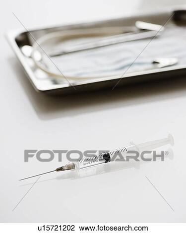 Syringe beside tray of medical supplies View Large Photo Image Stock Image - Syringe beside tray of medical supplies. Fotosearch