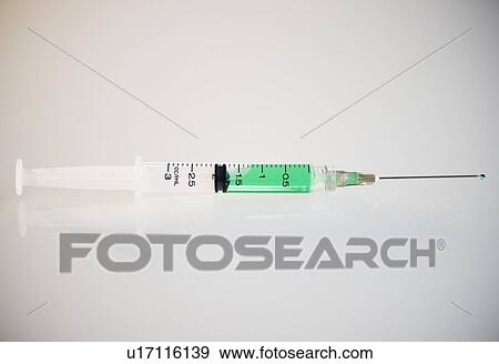 Stock Photo - Syringe filled with green liquid. Fotosearch