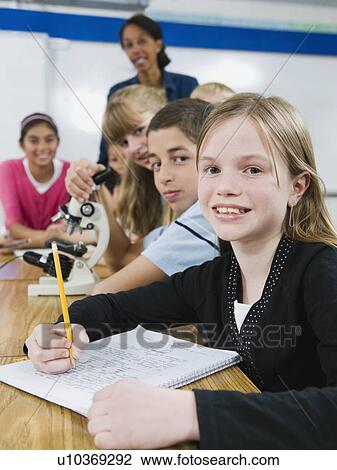Teacher and elementary students looking at microscope View Large Photo Image Stock Image - Teacher and elementary students looking at microscope. Fotosearch