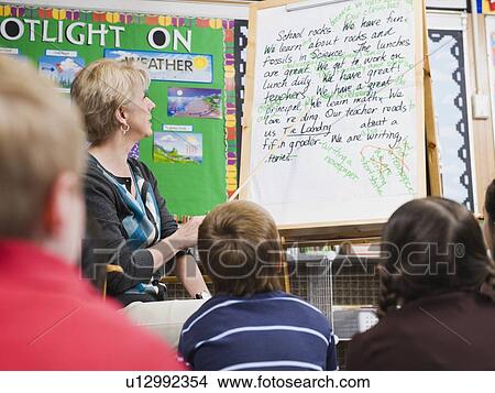 Picture - Teacher giving classroom presentation to students. Fotosearch
