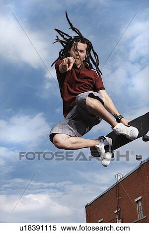 Stock Photography - Teenage boy doing skateboard jump. Fotosearch