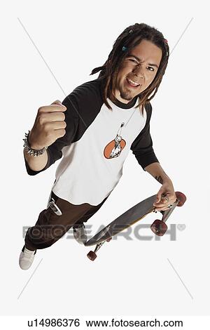 Teenage boy holding skateboard View Large Photo Image Stock Photograph - Teenage boy holding skateboard. Fotosearch