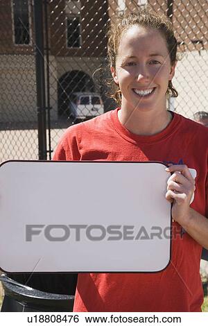 Stock Photograph - Teenage girl holding blank whiteboard. Fotosearch