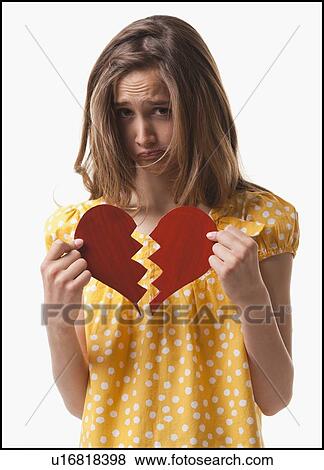 Teenage girl holding broken heart View Large Photo Image Stock Photo - Teenage girl holding broken heart. Fotosearch