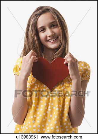 Teenage girl holding heart View Large Photo Image Stock Image - Teenage girl holding heart. Fotosearch