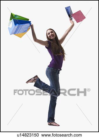 Stock Image - Teenage girl holding shopping bags. Fotosearch