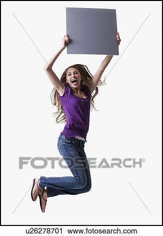 Stock Image - Teenage girl jumping for joy. Fotosearch