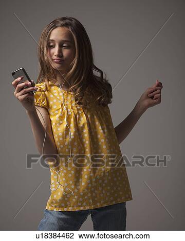 Teenage girl listening to music on I pod View Large Photo Image Stock Image - Teenage girl listening to music on I pod. Fotosearch