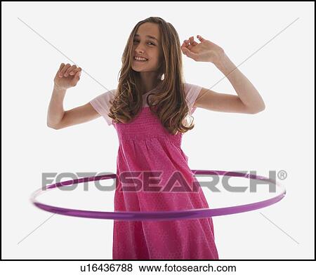 Teenage girl playing with a hula hoop View Large Photo Image Stock Photo - Teenage girl playing with a hula hoop. Fotosearch