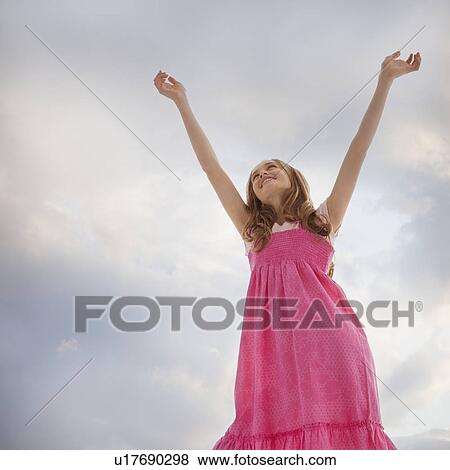 Stock Photo - Teenage girl raising her arms in the air. Fotosearch