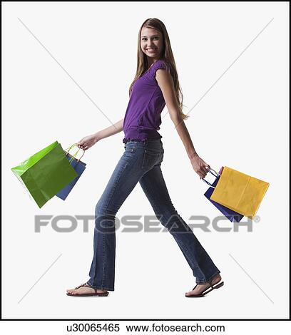 Teenage girl walking with several shopping bags View Large Photo Image Stock Photography - Teenage girl walking with several shopping bags. Fotosearch