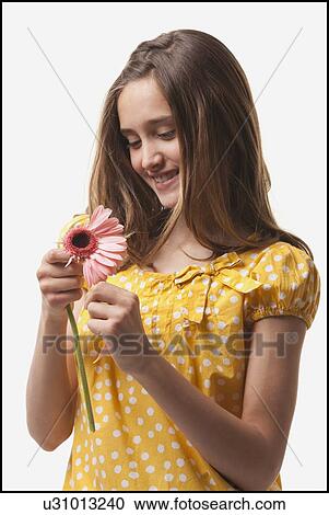 Teenage girls picking petals off of a flower View Large Photo Image Stock Image - Teenage girls picking petals off of a flower. Fotosearch