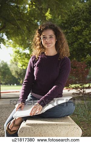 Teenage student sitting on park bench View Large Photo Image Stock Image - Teenage student sitting on park bench. Fotosearch