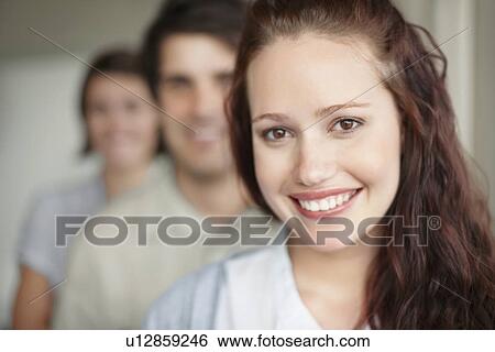 Three people standing in a row View Large Photo Image Stock Photograph - Three people standing in a row. Fotosearch