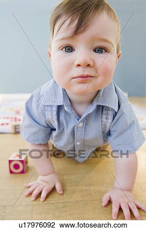 Stock Image - Toddler crawling on floor. Fotosearch