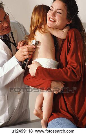 Toddler hugging her mother during medical check-up View Large Photo Image Stock Photo - Toddler hugging her mother during medical check-up. Fotosearch