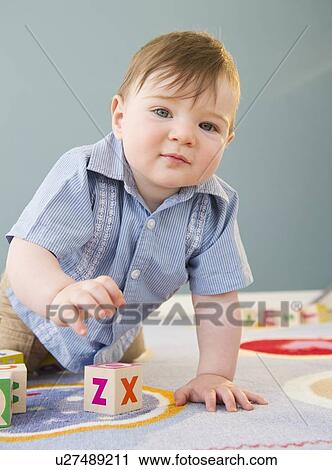 Stock Image - Toddler playing with blocks. Fotosearch