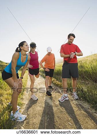 Stock Image - Trail runners taking a break. Fotosearch