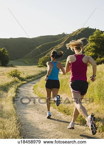Two female trail runners View Large Photo Image Stock Photo - Two female trail runners. Fotosearch