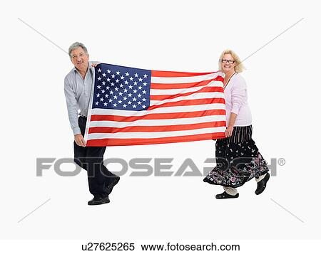 Two people carrying the American flag View Large Photo Image Stock Photography - Two people carrying the American flag. Fotosearch