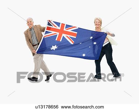 Stock Photograph - Two people carrying the Australian flag. Fotosearch