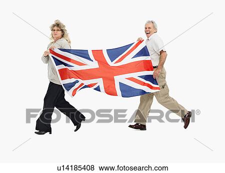 Stock Photo - Two people carrying the British flag. Fotosearch