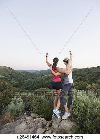 Two women raising their arms in victory View Large Photo Image Picture - Two women raising their arms in victory. Fotosearch