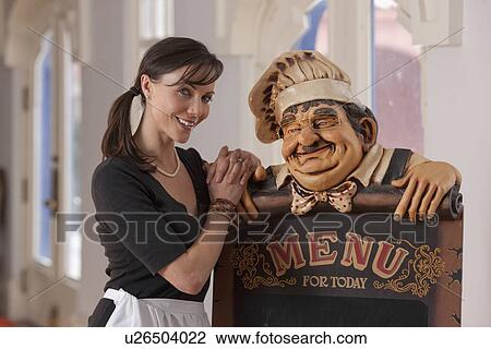 Waitress standing beside menu sign View Large Photo Image Stock Image - Waitress standing beside menu sign. Fotosearch