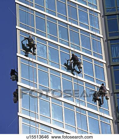 Window washers cleaning windows on skyscraper View Large Photo Image Stock Photograph - Window washers cleaning windows on skyscraper. Fotosearch