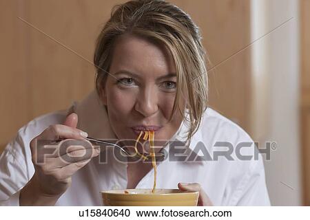 Stock Image - Woman eating spaghetti. Fotosearch
